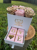 Bouquet of gold and pink roses preserved in a box with 'Love Details' branding on a grassy background - Lovy Details Miami