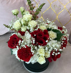 Bouquet of red and white flowers in a pot on a light background - Lovy Details Miami