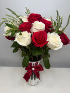 Bouquet of red and white roses in a silver vase with a red bow on a gray background - Lovy Details Miami