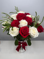 Bouquet of red and white roses in a vase with a decorative bow on a gray background - Lovy Details Miami